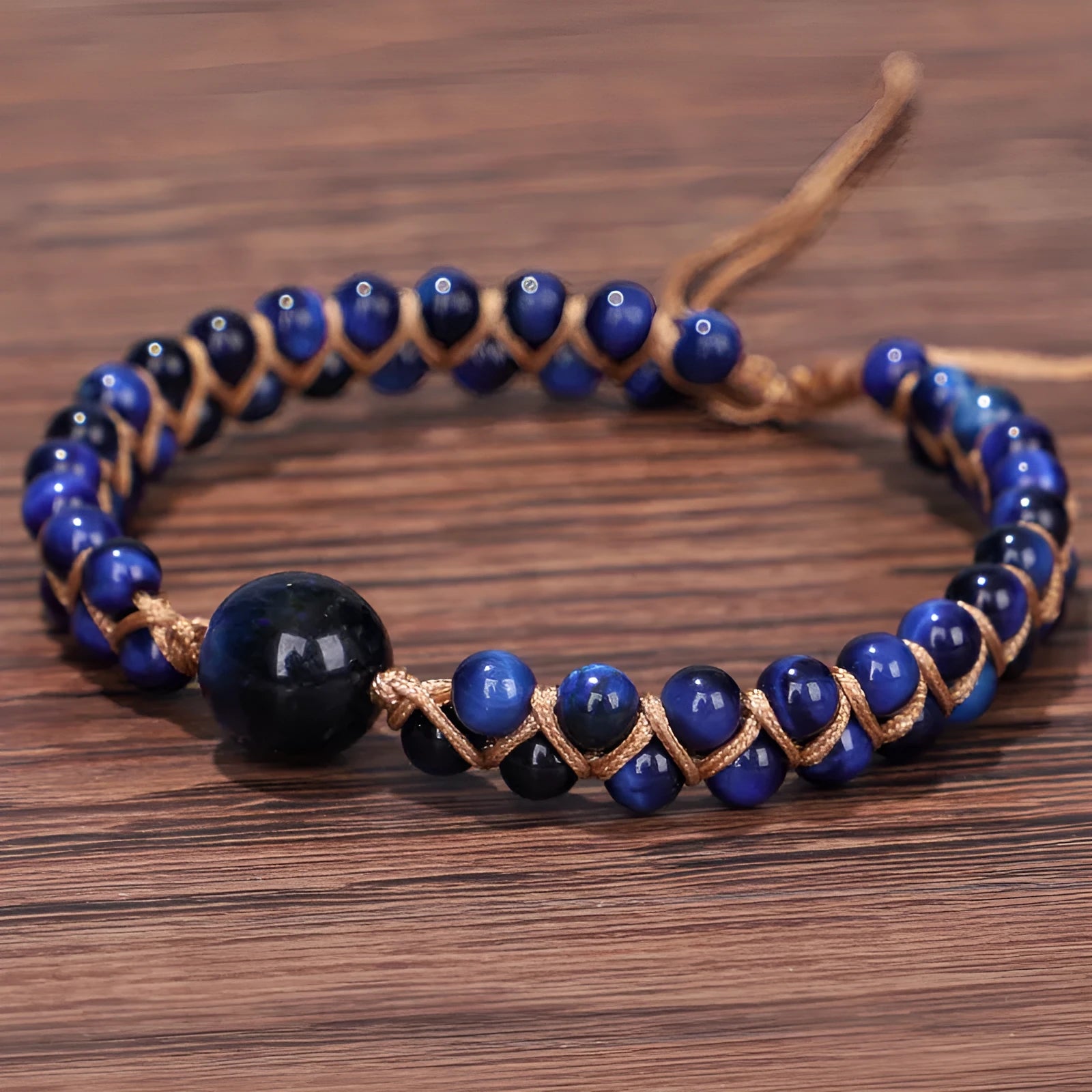 Handmade woven geometric pull bracelet with blue tigereye stone beads.