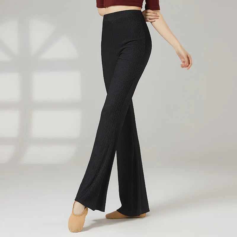 Women's solid colour dance practice pants in stretch polyester fabric on a hanger.