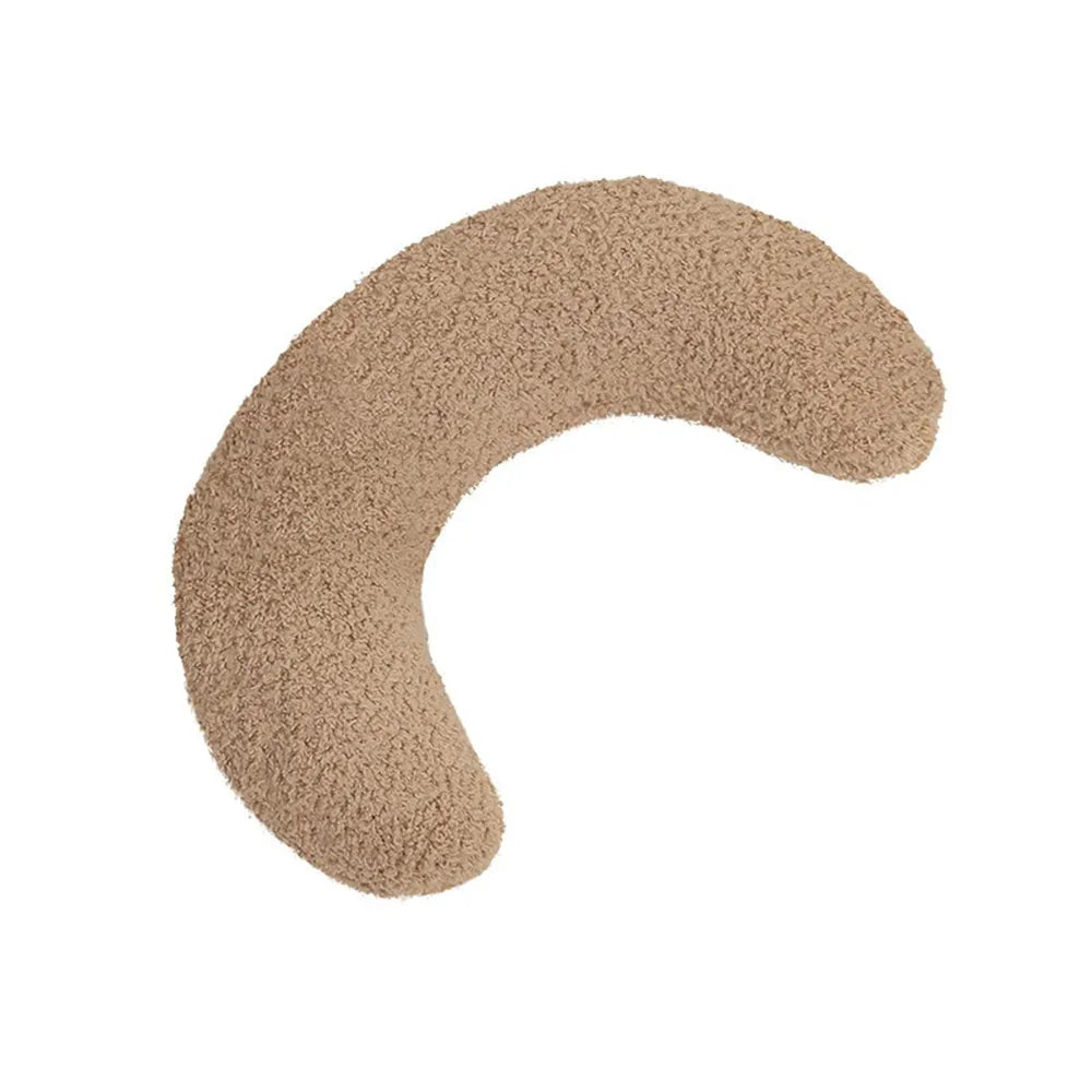 Blue U-shaped cat pillow with an adjustable fabric collar on a grey sofa