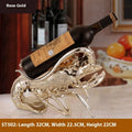Lobster-shaped resin wine rack ornament in rose gold or silver, holding a wine bottle.