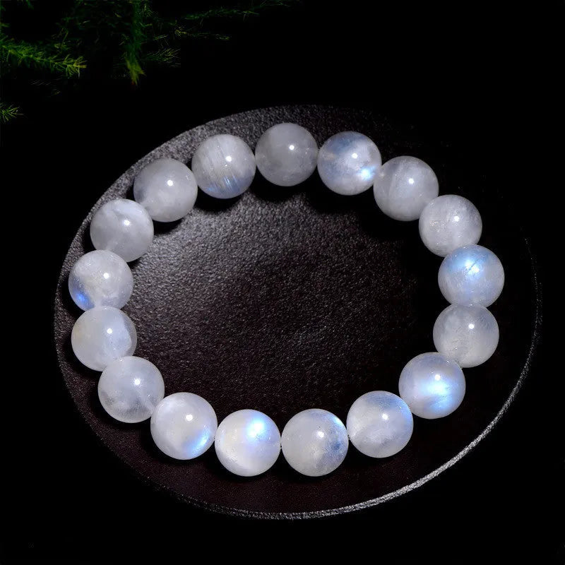 Natural blue moonlight round bead moonstone bracelet showing polished gemstone beads on wrist