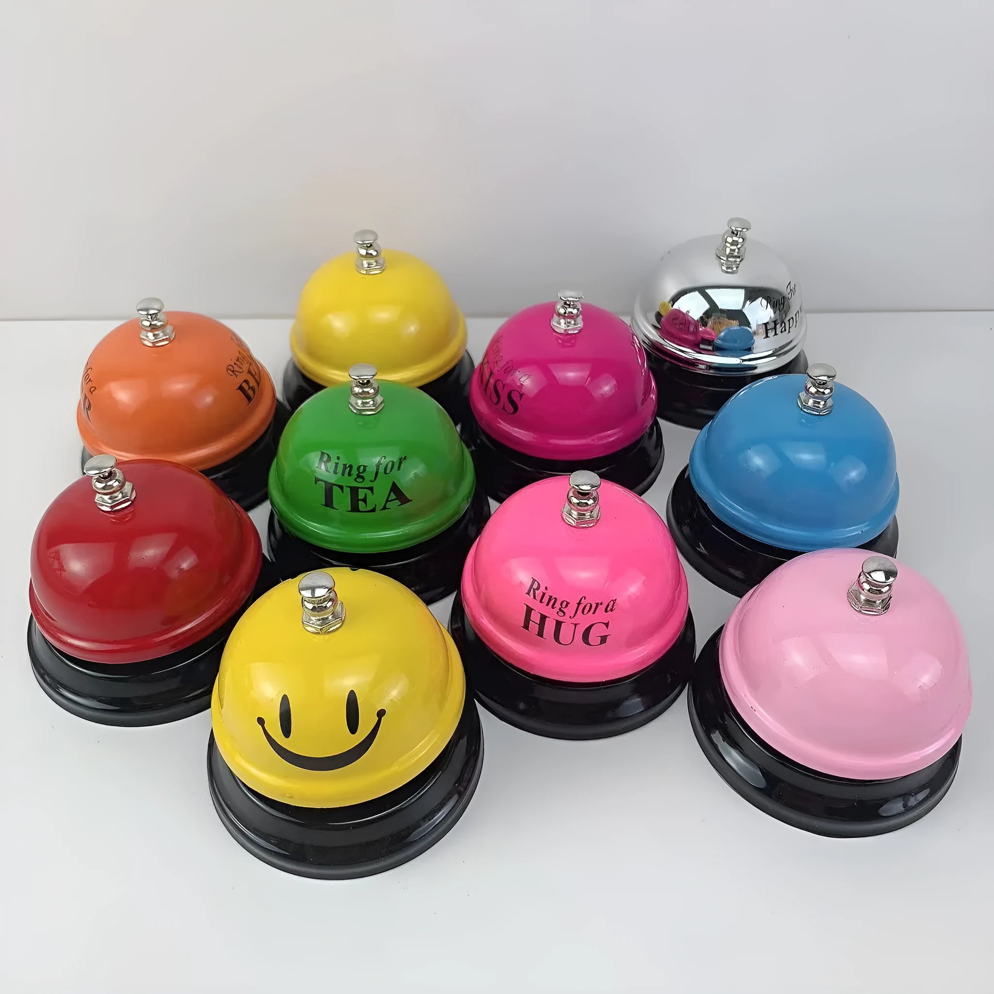 Iron hand bell with handle in one of eleven available colours, including red, green, blue, and pink.