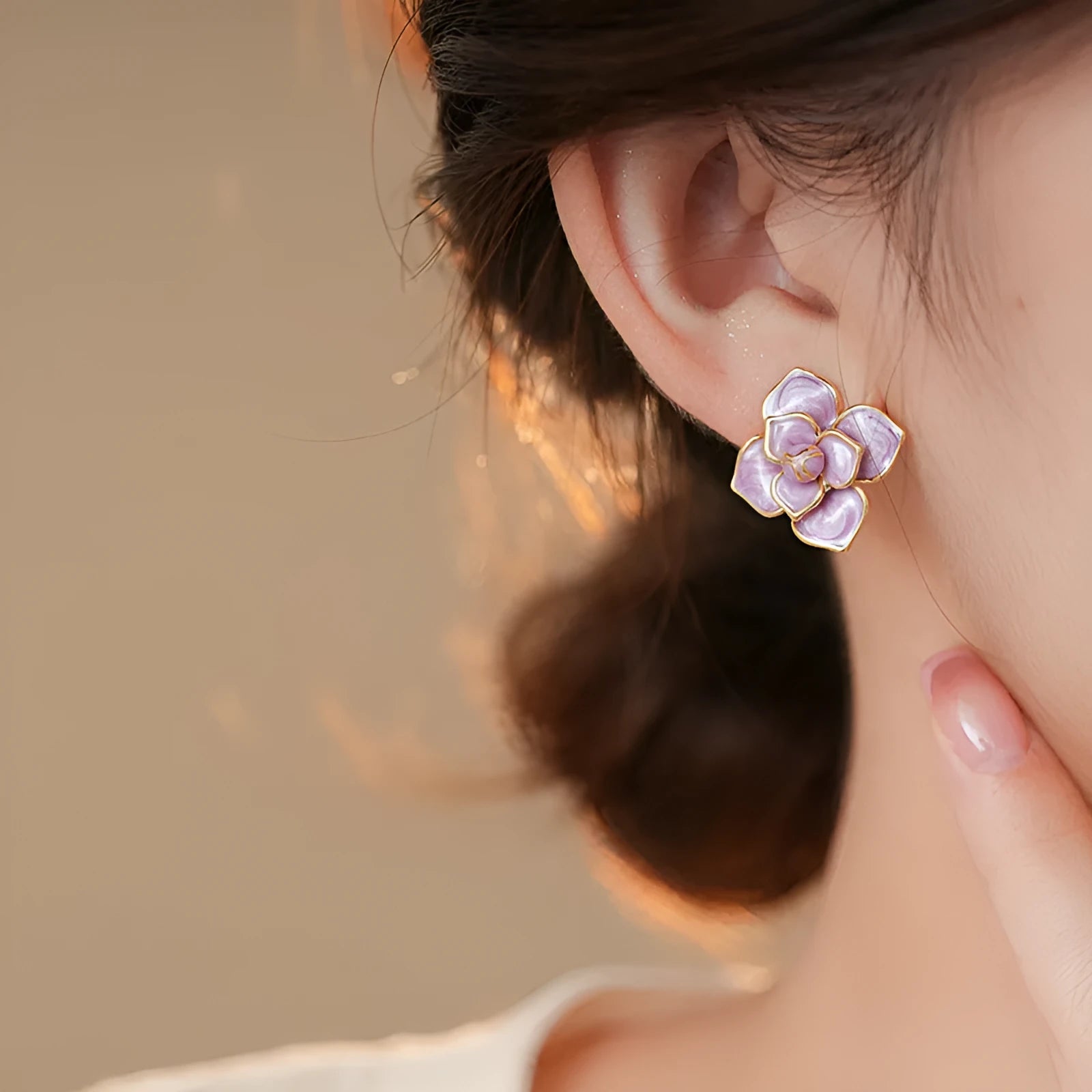 Gold plated flower stud earrings with a purple oil-spot glaze finish on copper.