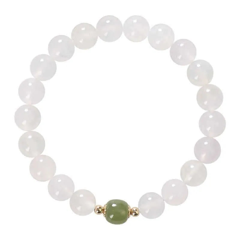 Handmade white agate and crystal bracelet with cinnabar inlay showing letter modelling on 8mm beads.