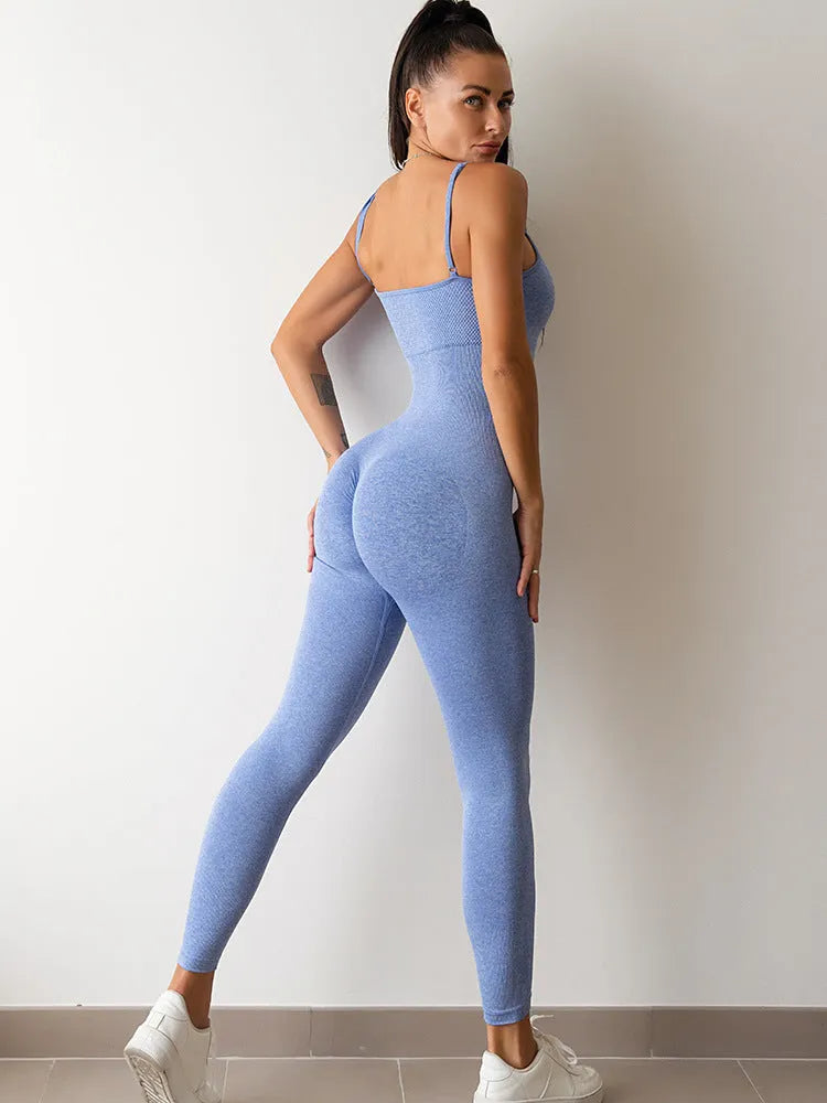 A woman wearing a black sleeveless jumpsuit with thin spaghetti straps and a backless design.