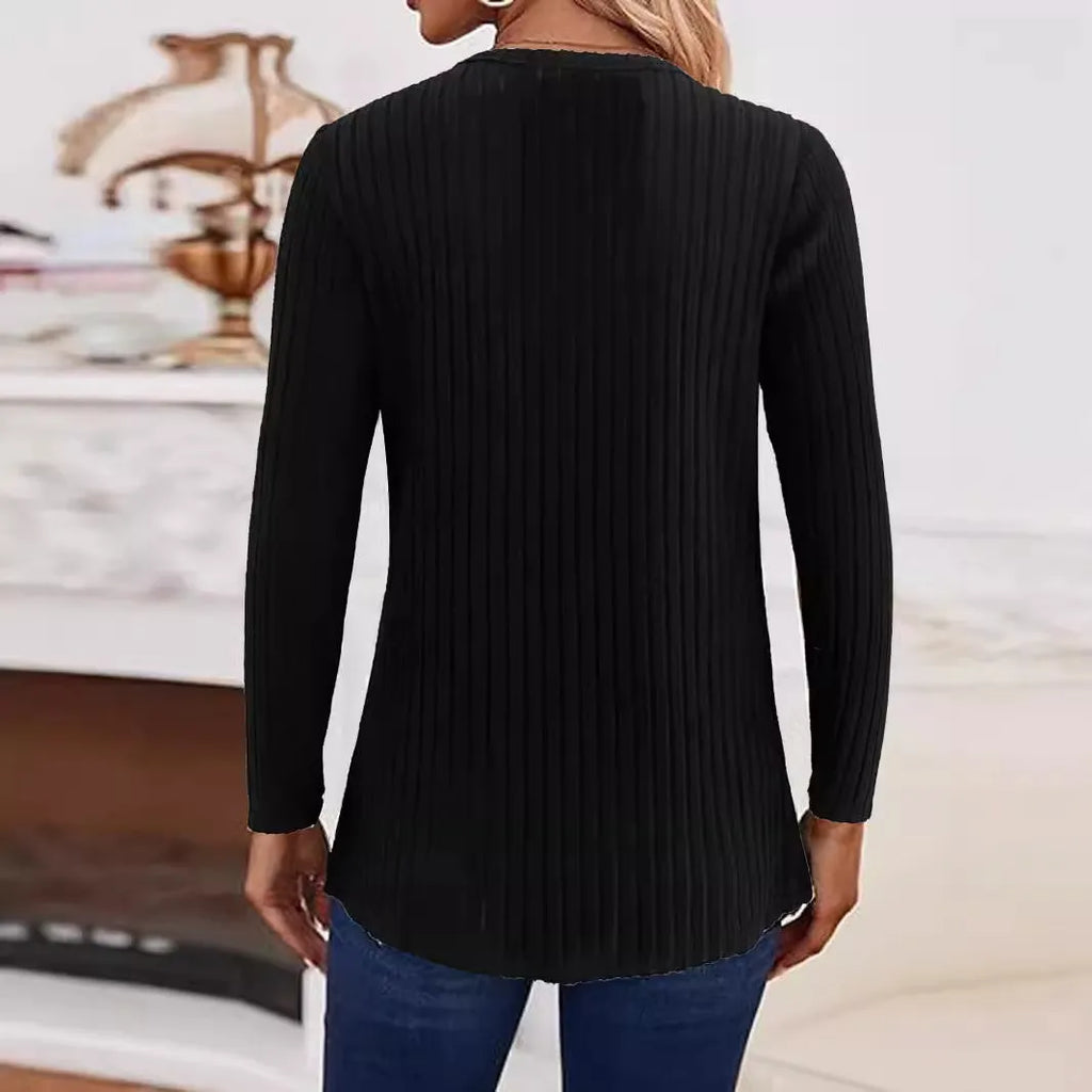 A solid colour casual knitted sweater with a button detail, shown in grey green.