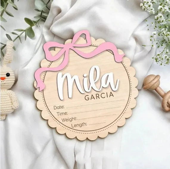 Square wooden baby room ornament with space for a customised name, shown in two size options.