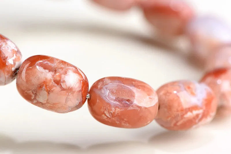 Natural cherry agate bracelet with barrel-shaped beads and Ruyi design element