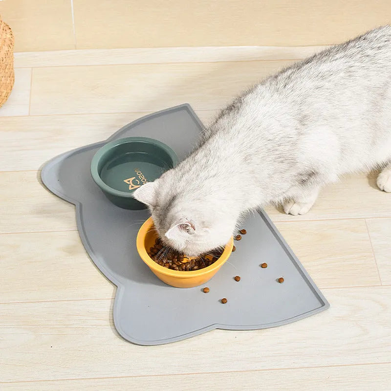 Solid colour silicone pet feeding mat placed under dog bowl on floor
