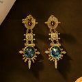 Gold geometric stud earrings with round shape and diamond treatment