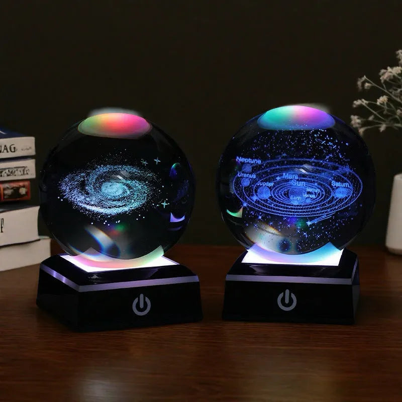 Transparent white crystal ball night light with 3D inner carving of Milky Way on black square colourful base