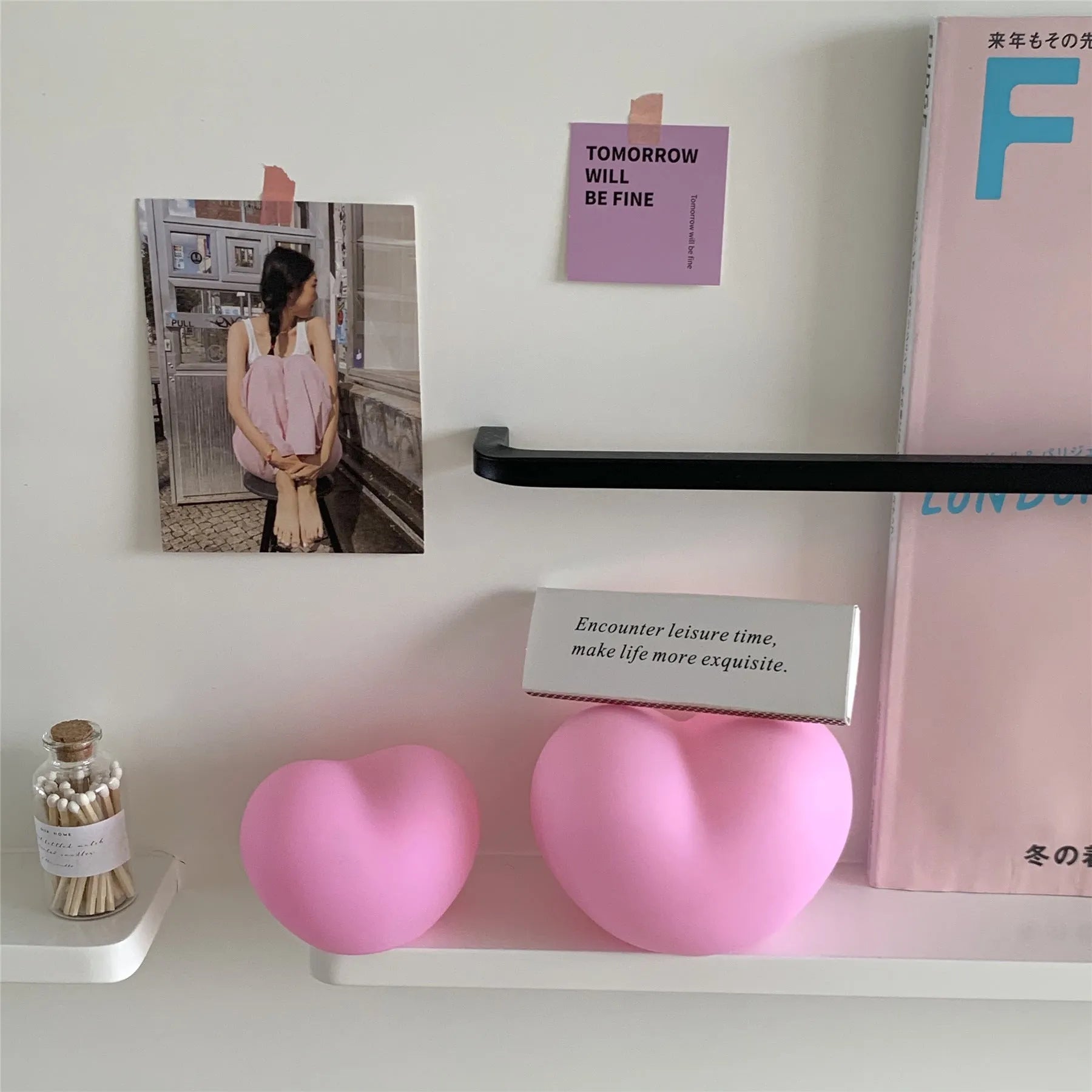 Small pink vinyl atmosphere lamp glowing with warm light on a wooden surface.