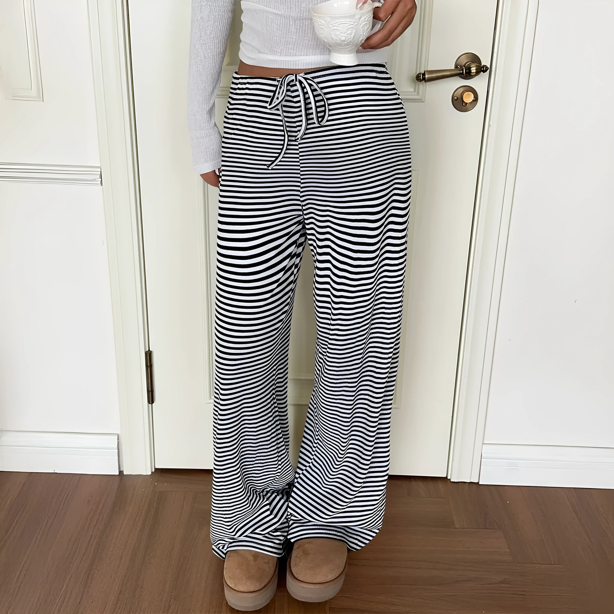 Women's mid-rise straight-leg trousers in black and white stripe pattern, polyester fabric, front view