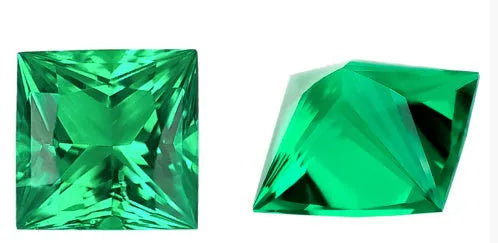 Loose cultivated emerald gemstone in Columbia green treasure colour on a white background.