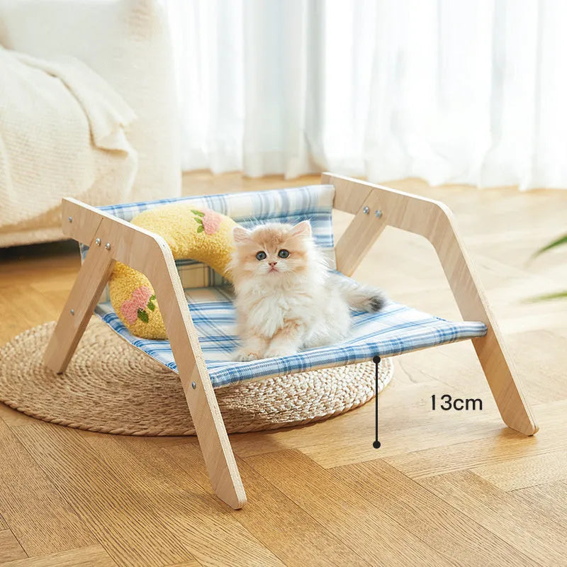 Wooden elevated cat bed hammock with cloth cushion in blue or green colour.