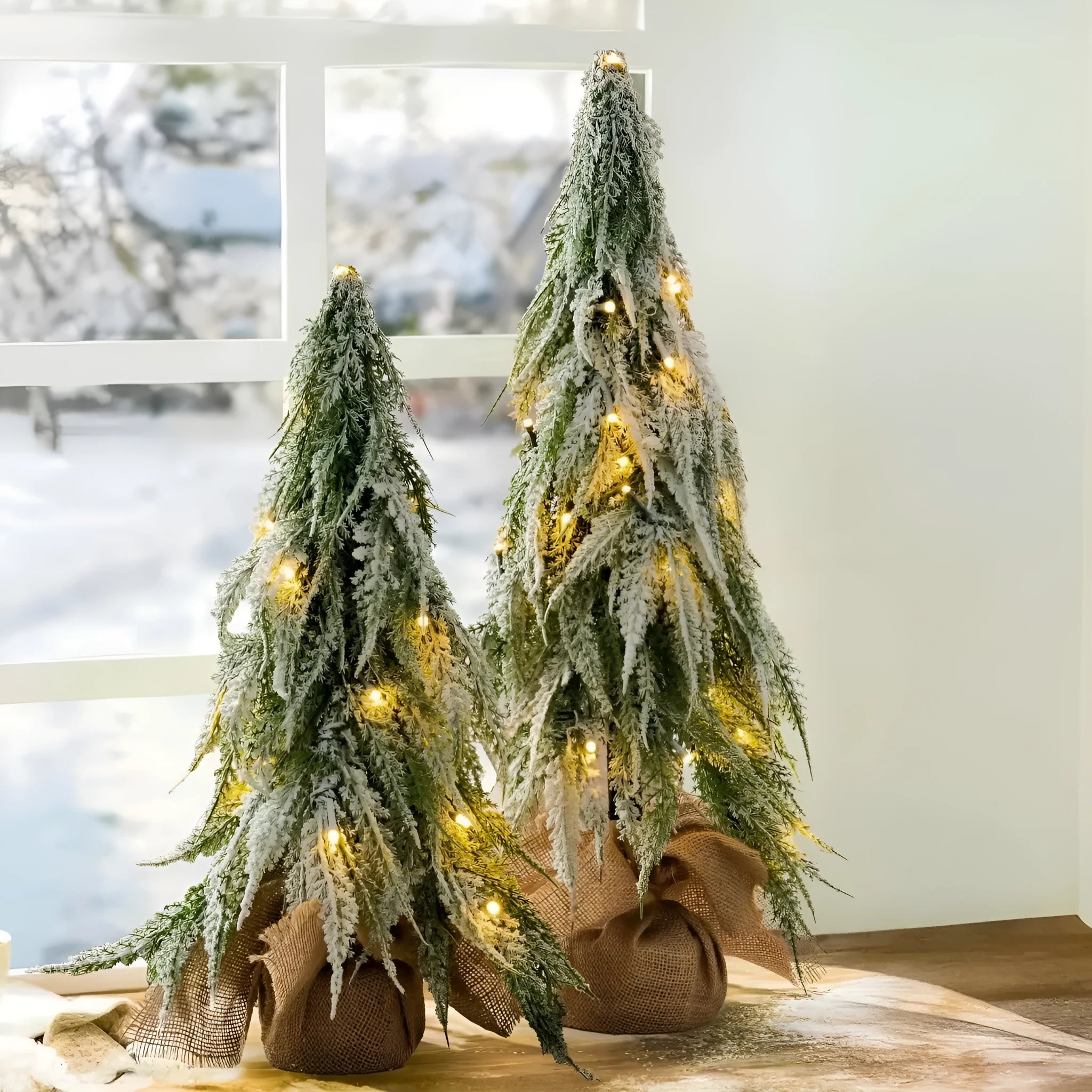 Small 24 inch white Christmas tree with built-in lights and simulated snow sprayer effect on branches