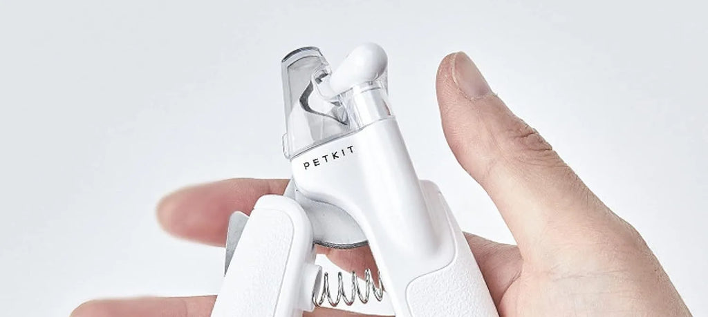 White pet nail clippers with LED light, anti-splash transparent guard, and a leather-like handle on a blue background.
