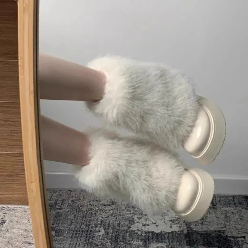 Women's black artificial plush snow boots with a low-top design and a waterproof rubber platform sole.