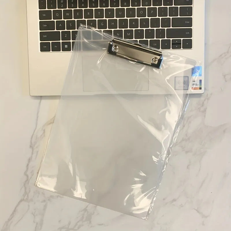 A4 transparent plate clipboard with metal clip, shown in blue colour on a desk with paper.