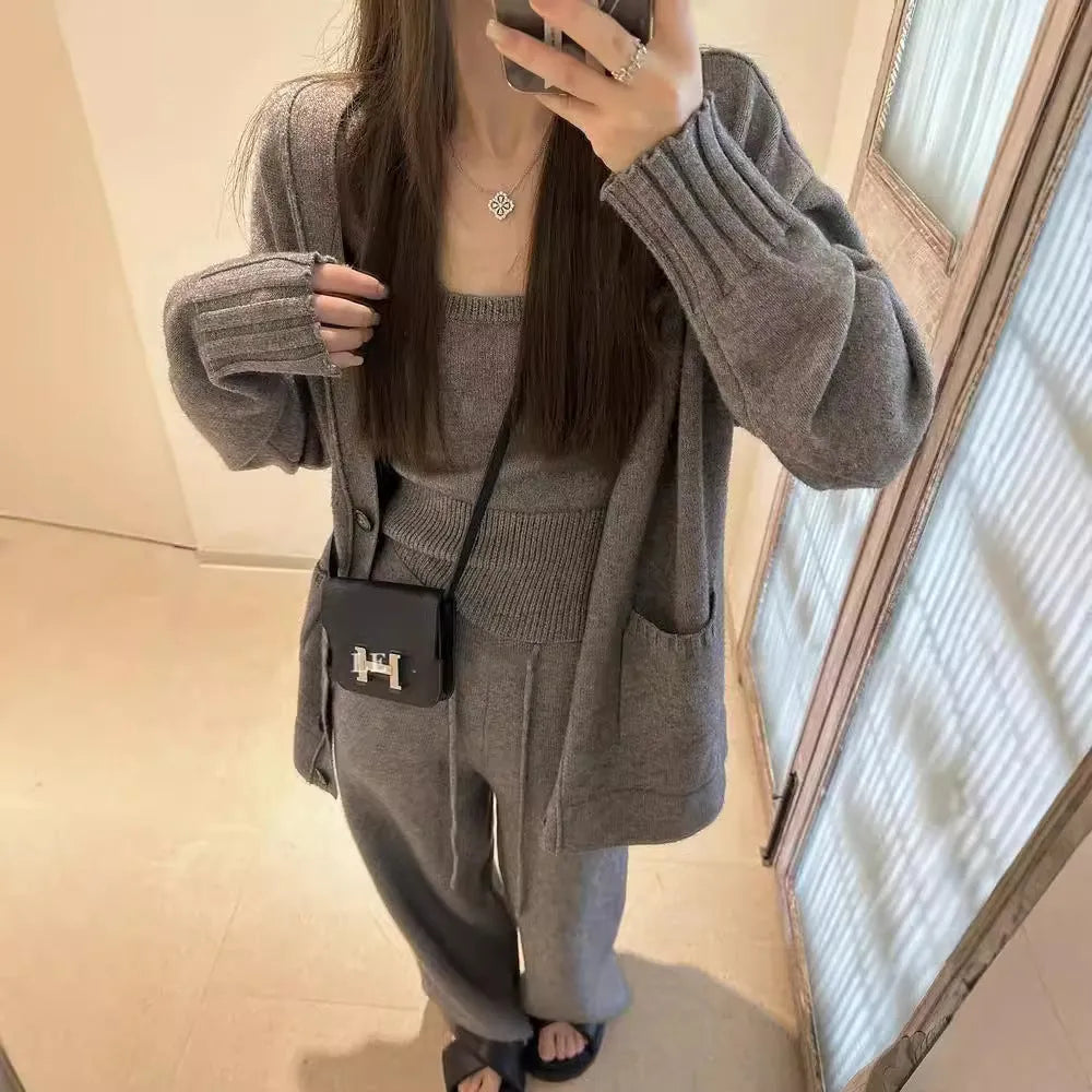 Women's light brown knit cardigan and suspender pants three-piece casual set on a hanger.