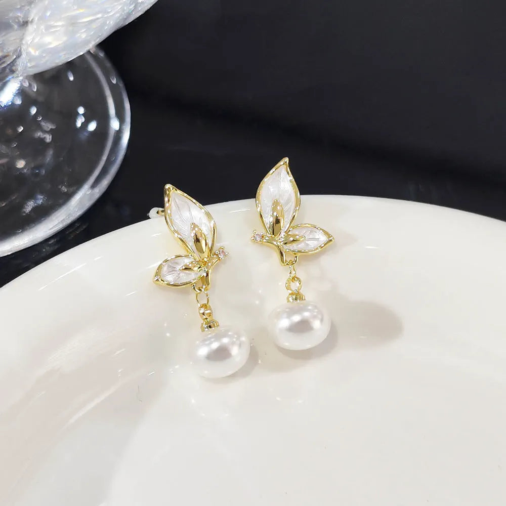 A pair of simple style copper butterfly earrings for women with an electroplated painted oil design.