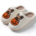 Black and white Halloween pumpkin plush slippers with round toe design and TPR rubber soles