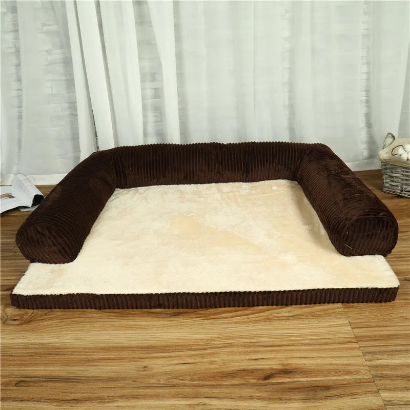 Corduroy pet sofa dog bed with bolster sides, shown in grey colour on a wooden floor