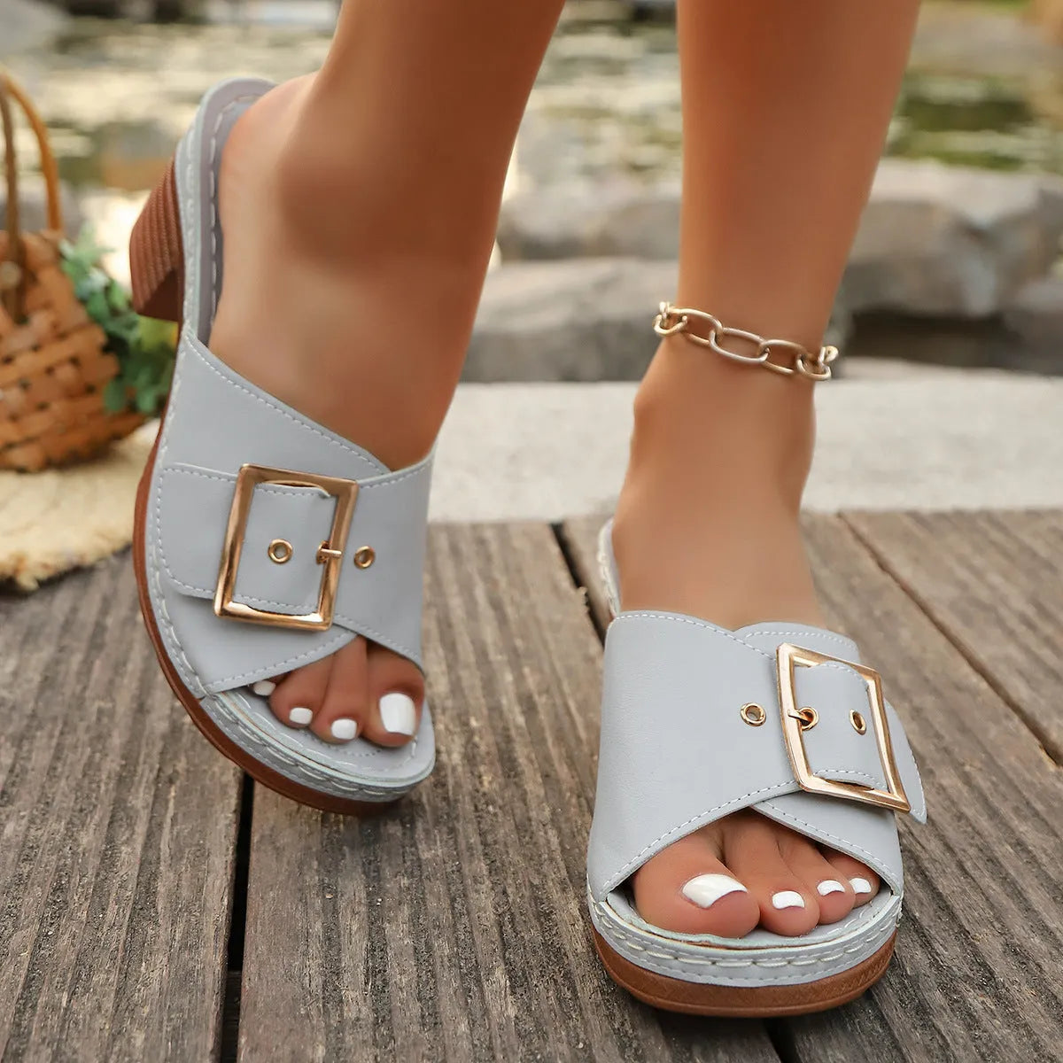 Women's black retro chunky heel slippers with a large metal buckle on the strap.