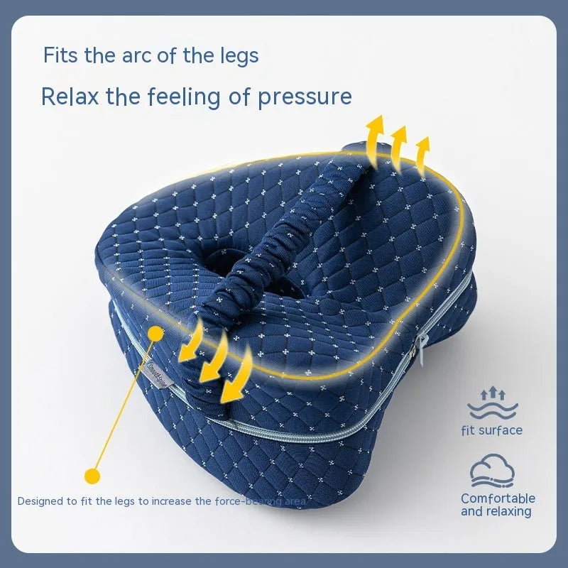Love heart-shaped dark blue jacquard memory foam leg pillow for adults on a bed.
