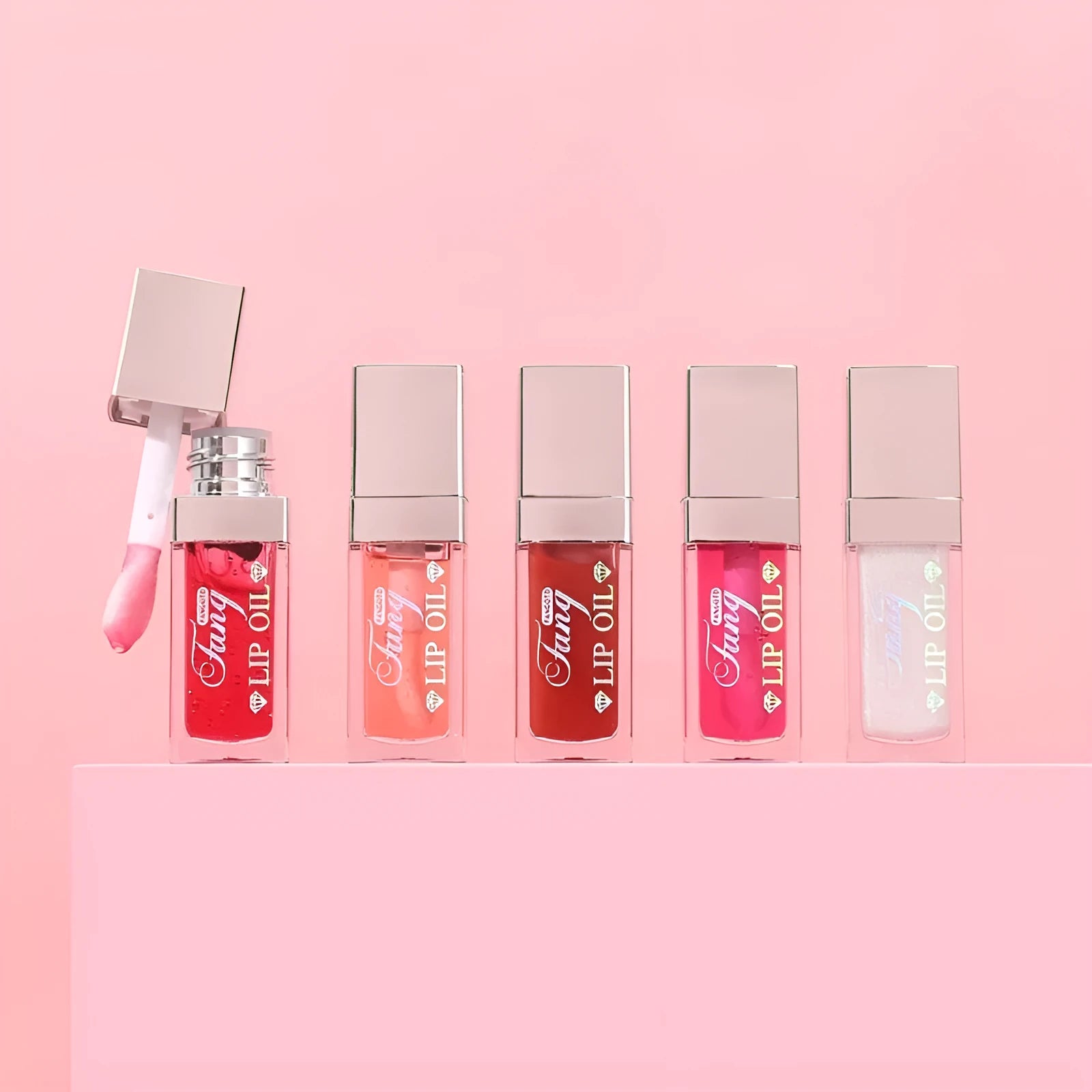 Set of five bright mint lip gloss tubes and one lip essence oil bottle for moisturising and repair.