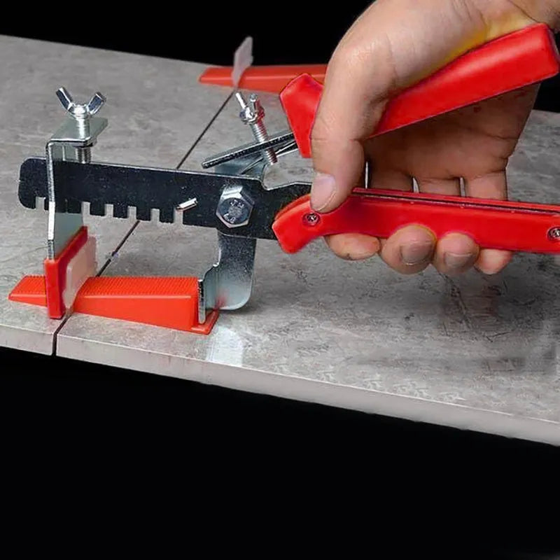 Red tile leveler aid with PVC handle and stainless steel clip measuring 23 by 11.5 centimetres
