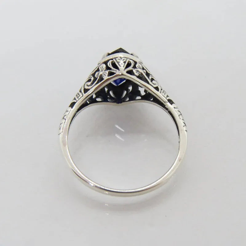 Women's silver geometric hollow-out alloy ring showing detailed pattern and zircon elements