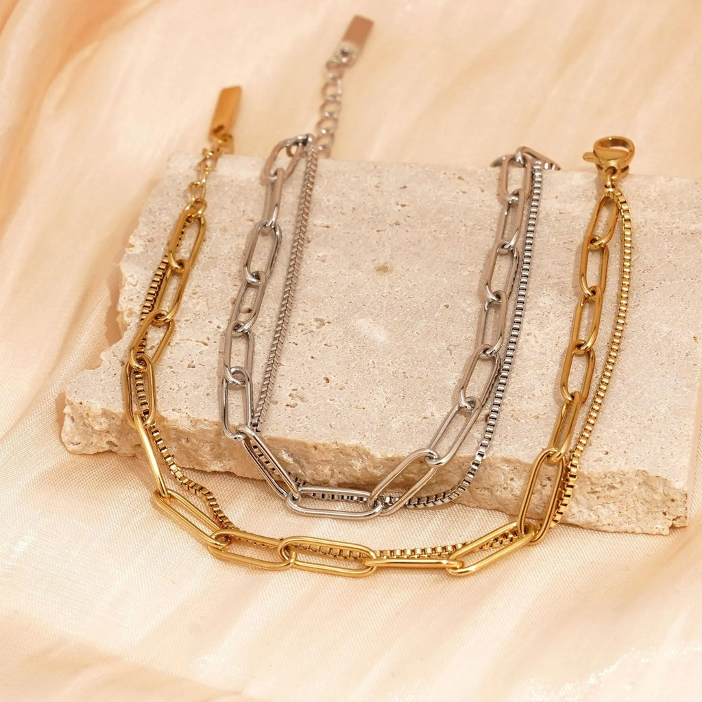 Geometric double layer stainless steel bracelet in gold or silver, showing Ins Cold Style design with linear elements.