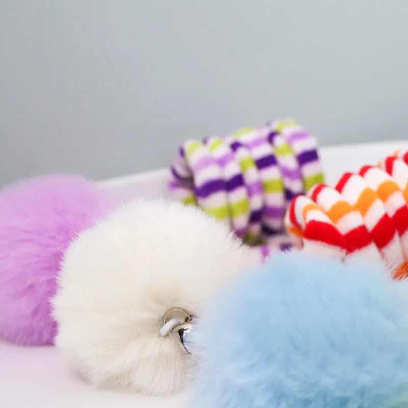 Spring cat toy with bell stick and inflatable ball hanging from door with suction cup