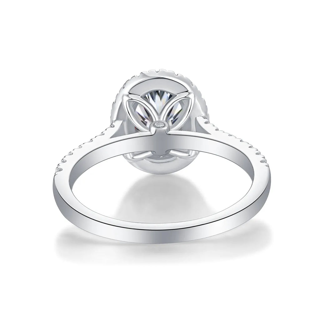Egg-shaped 7x9mm moissanite wedding ring in S925 silver with platinum plating on white background