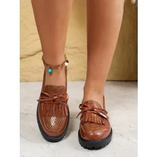 Women's black and brown casual loafers with a decorative bow on the artificial PU upper.