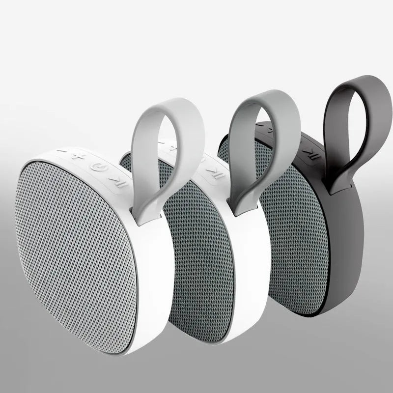 Wireless Bluetooth mini speaker with fabric waterproof cover and magnetic suction, available in black or white shell with grey or green cloth net