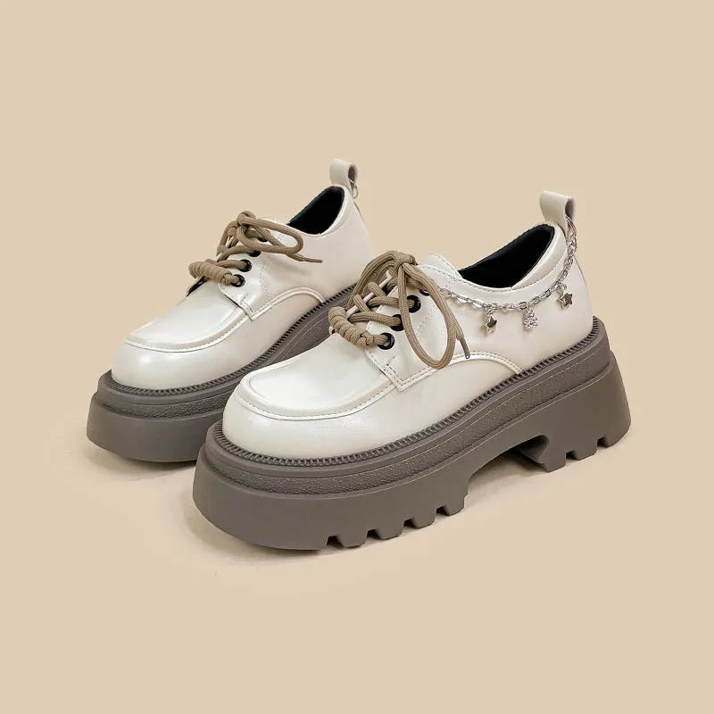 White PU platform Mary Jane shoes with thick chunky heel and front lace-up detail.
