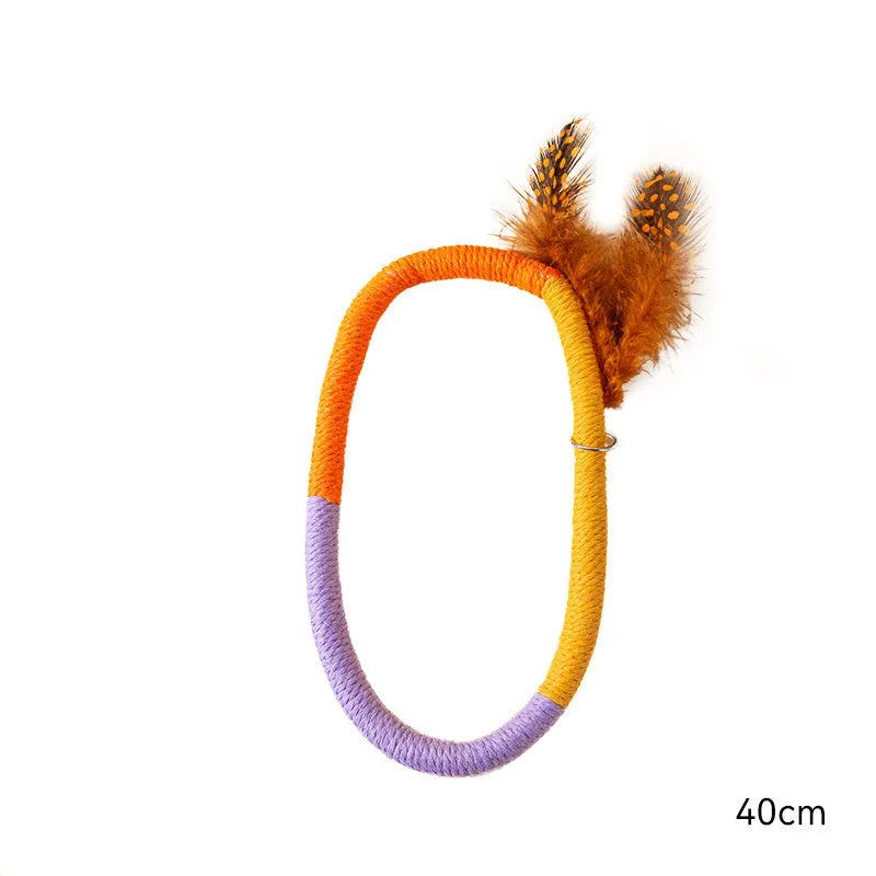 Green circular cotton rope cat toy with feathers and catnip for interactive play and dental cleaning