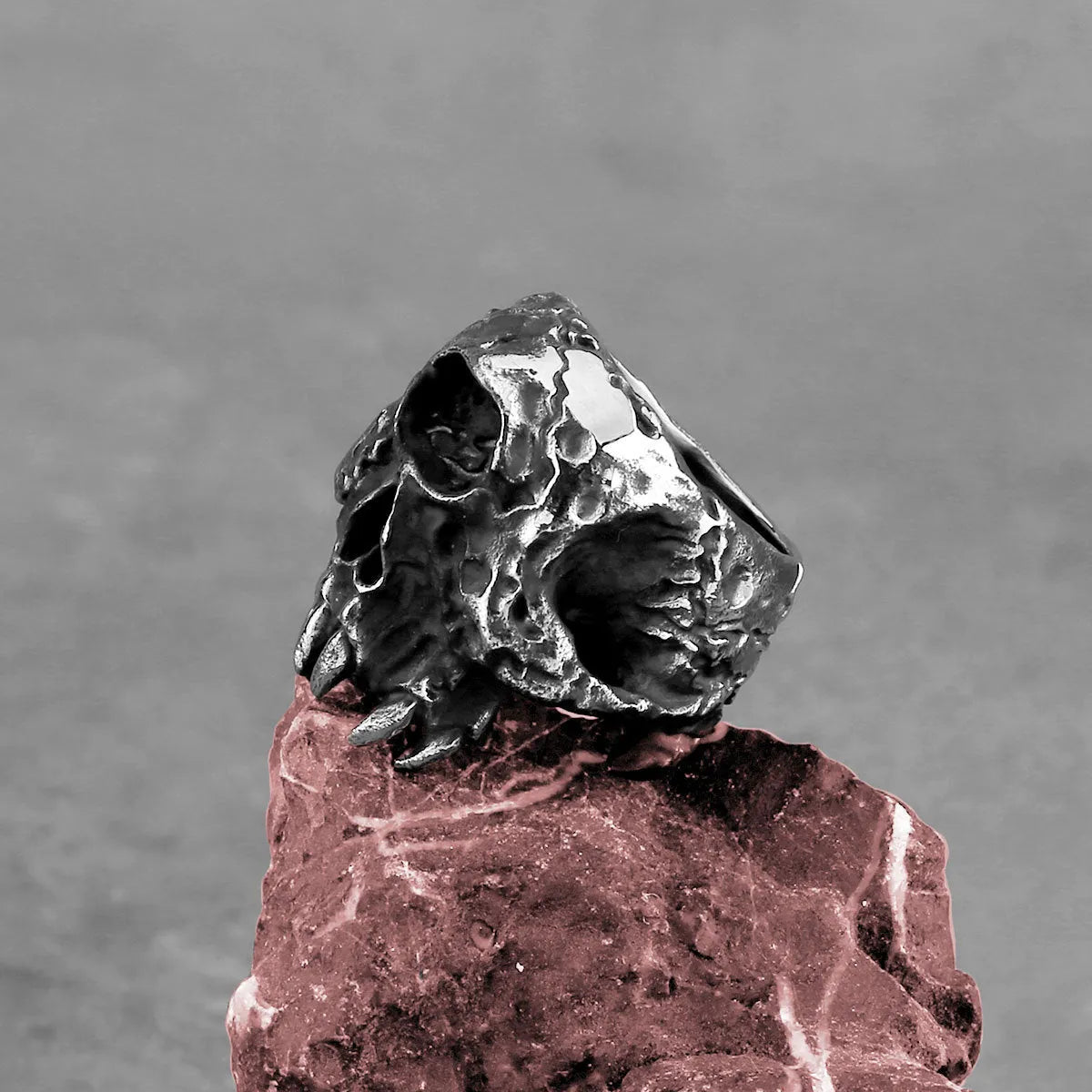 Silver alloy ring with a detailed one-eyed skull design in a retro punk style.