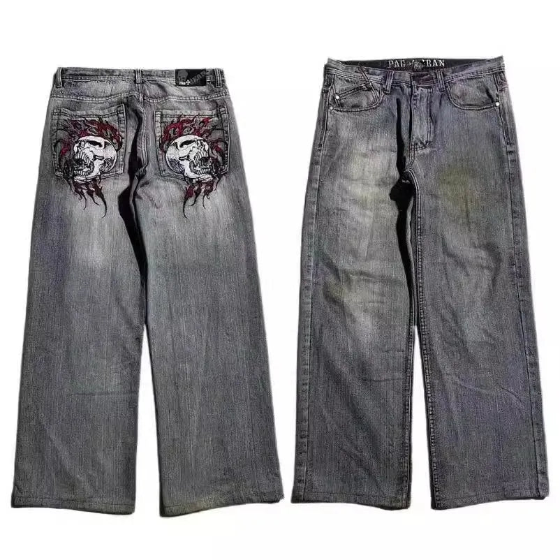 Grey washed-out denim jeans on a man, showing wide-leg straight cut and mid-waist fit.