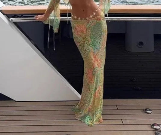 Green halterneck printed lace-up split swimsuit with long bell sleeves on model