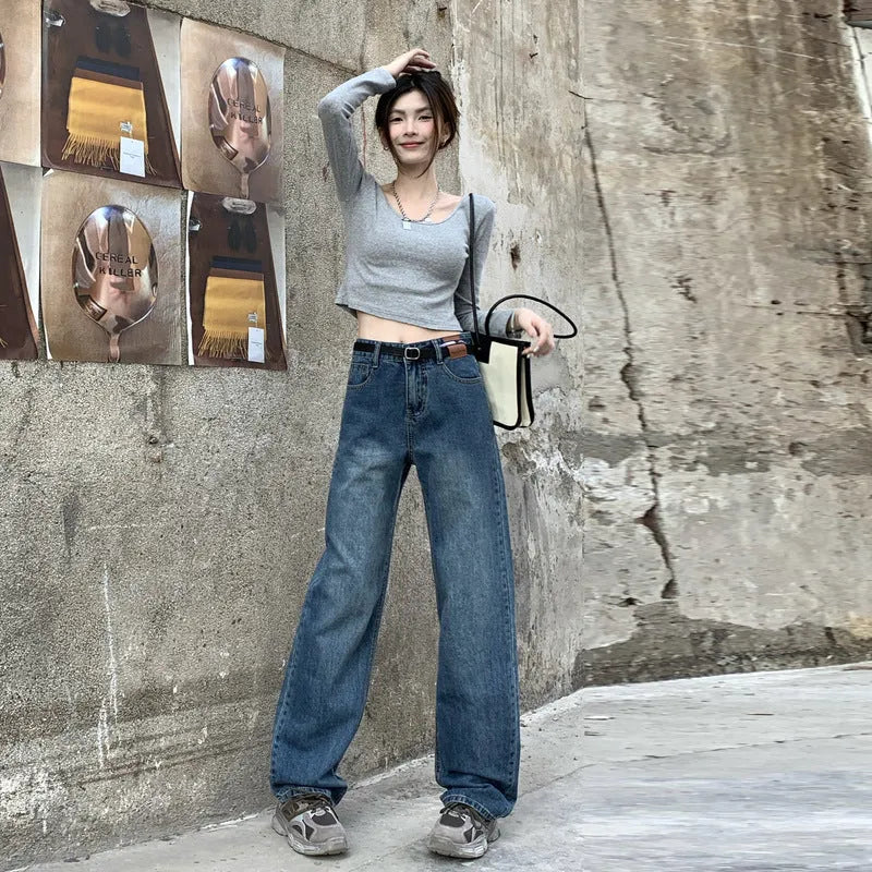 Women's high waist straight leg jeans in a retro blue wash, showcasing the denim fabric and cut.