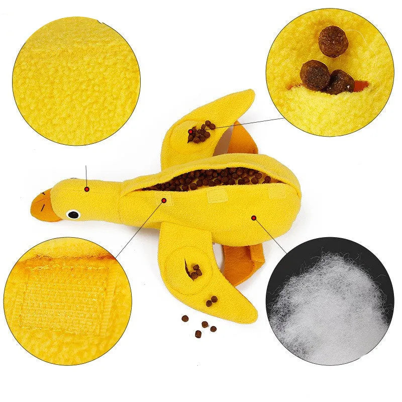 Yellow plush duck dog toy with squeaker and treat-dispensing feature for training and play.