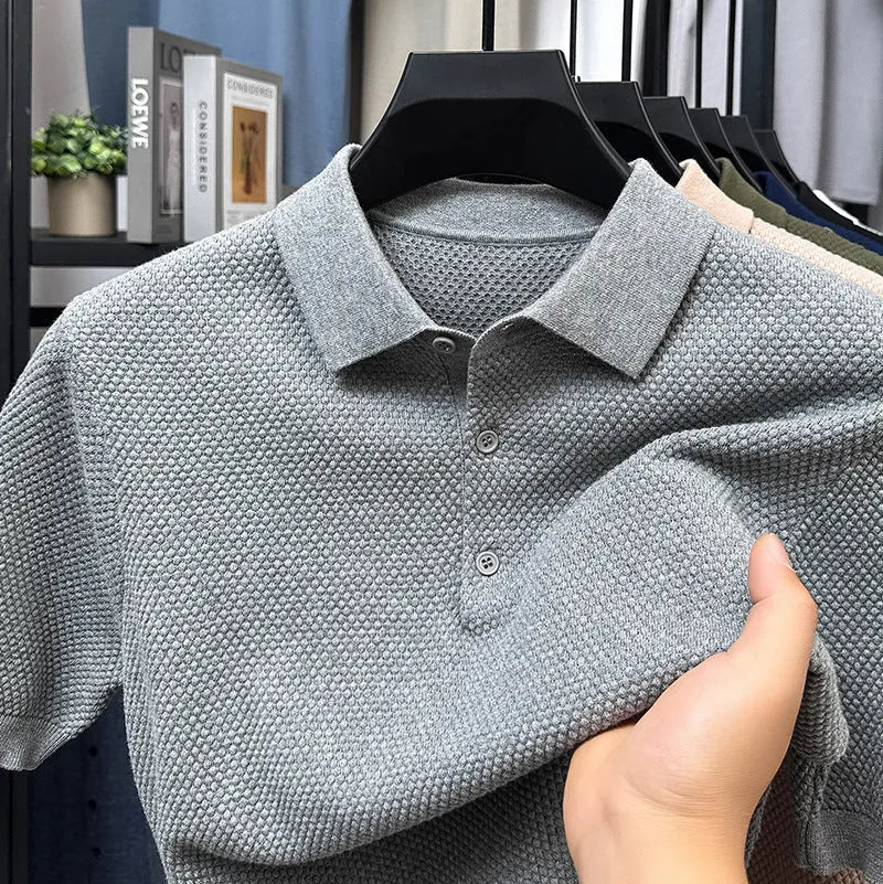 Loose fit grey cotton short sleeve pullover sweater laid flat.