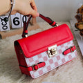 Small square retro pattern crossbody bag in PU leather with floral stitching.