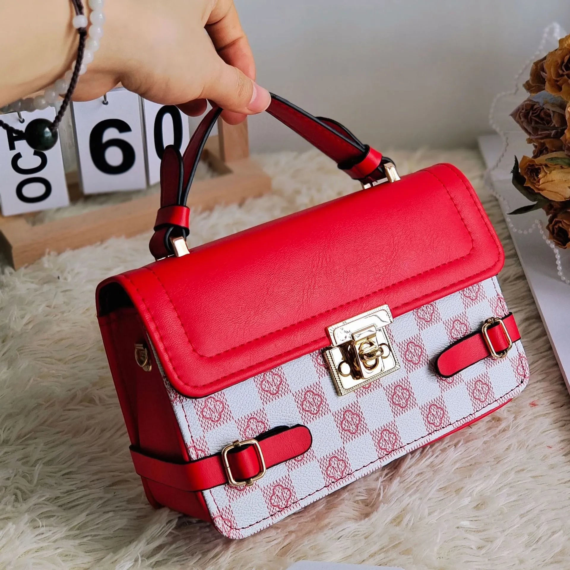 Small square retro pattern crossbody bag in PU leather with floral stitching.