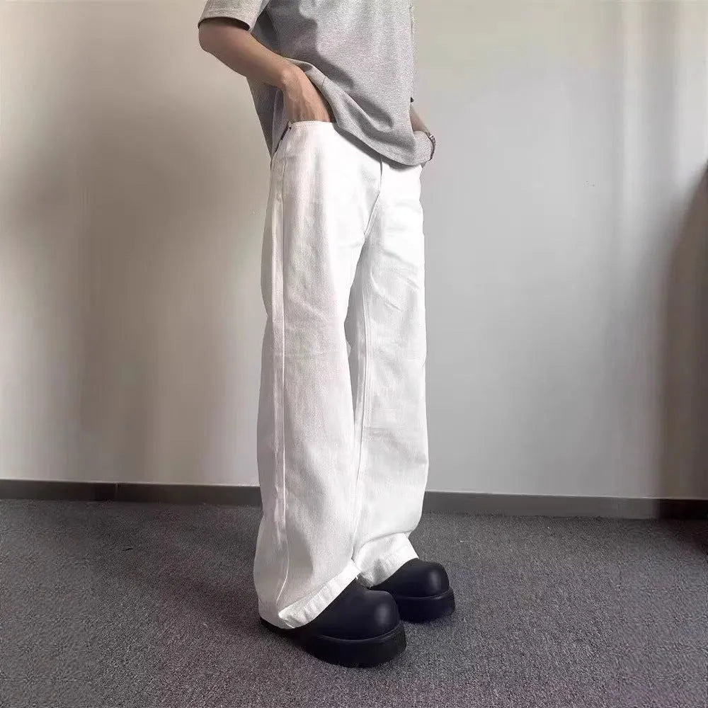 Men's white loose fit wide-leg straight denim jeans on a mid-waist model.