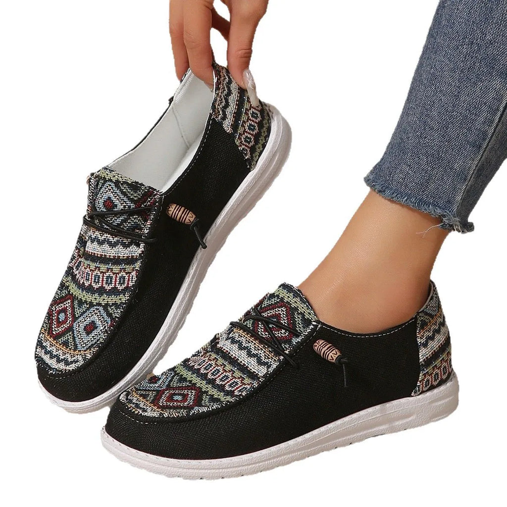 Women's black round toe flat shoes with a low-top PU upper and rubber sole on a plain background.