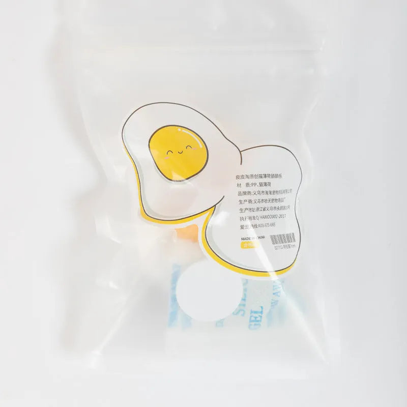 Interactive catnip ball toy stuck to wall with cat playing, showing fried egg and poached egg shape options